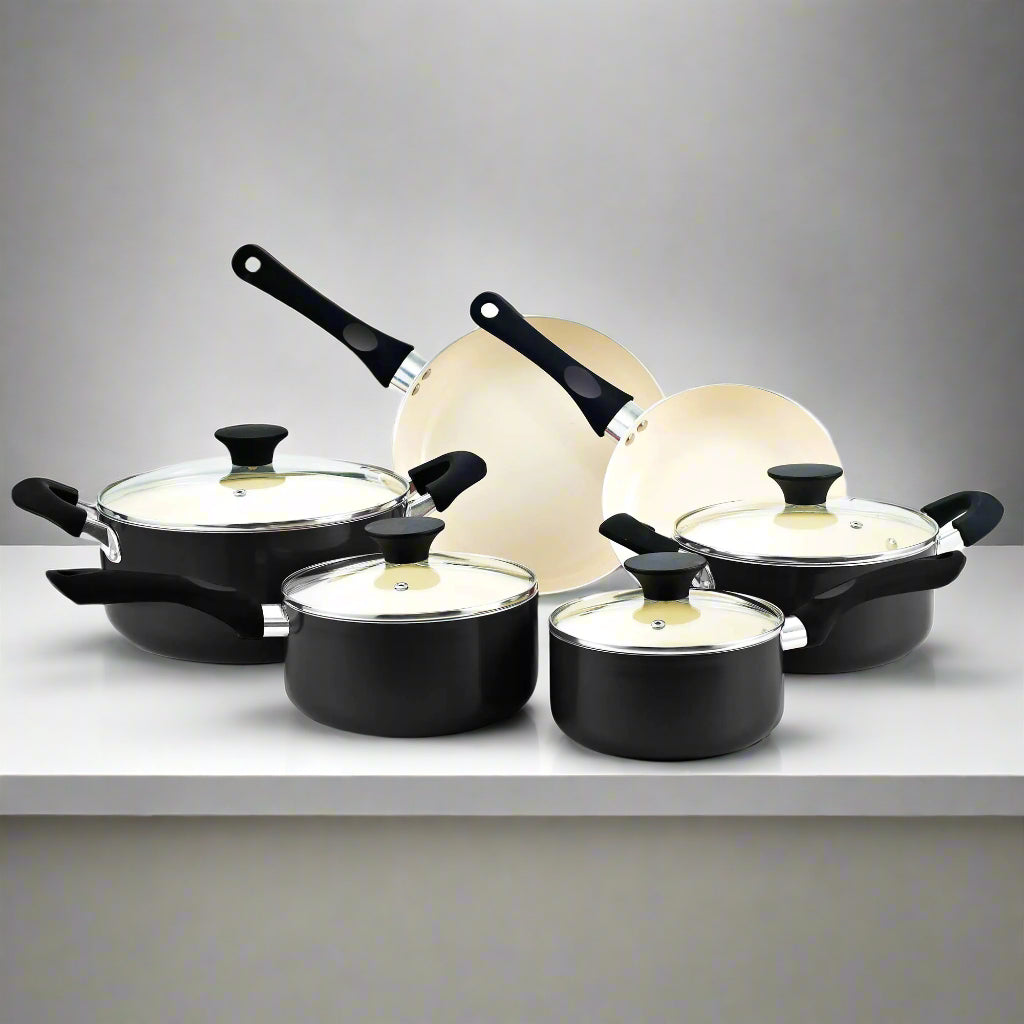 Set of black cookware with lids on a white background