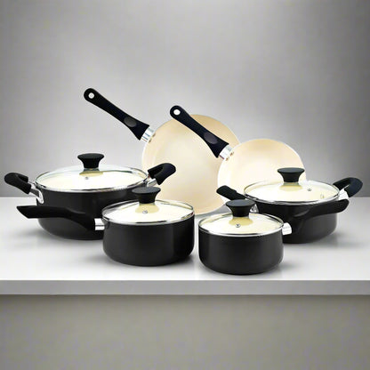 Set of black cookware with lids on a white background